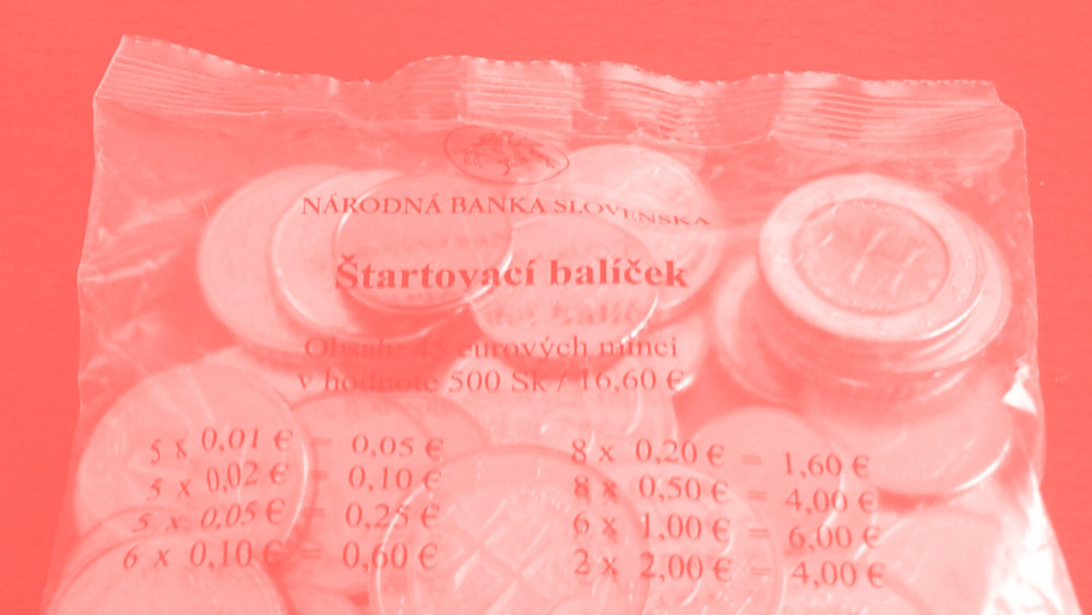 Salmon-coloured monochrome image. A plastic bag with Euro coins and Slovak text printed on it shines through.